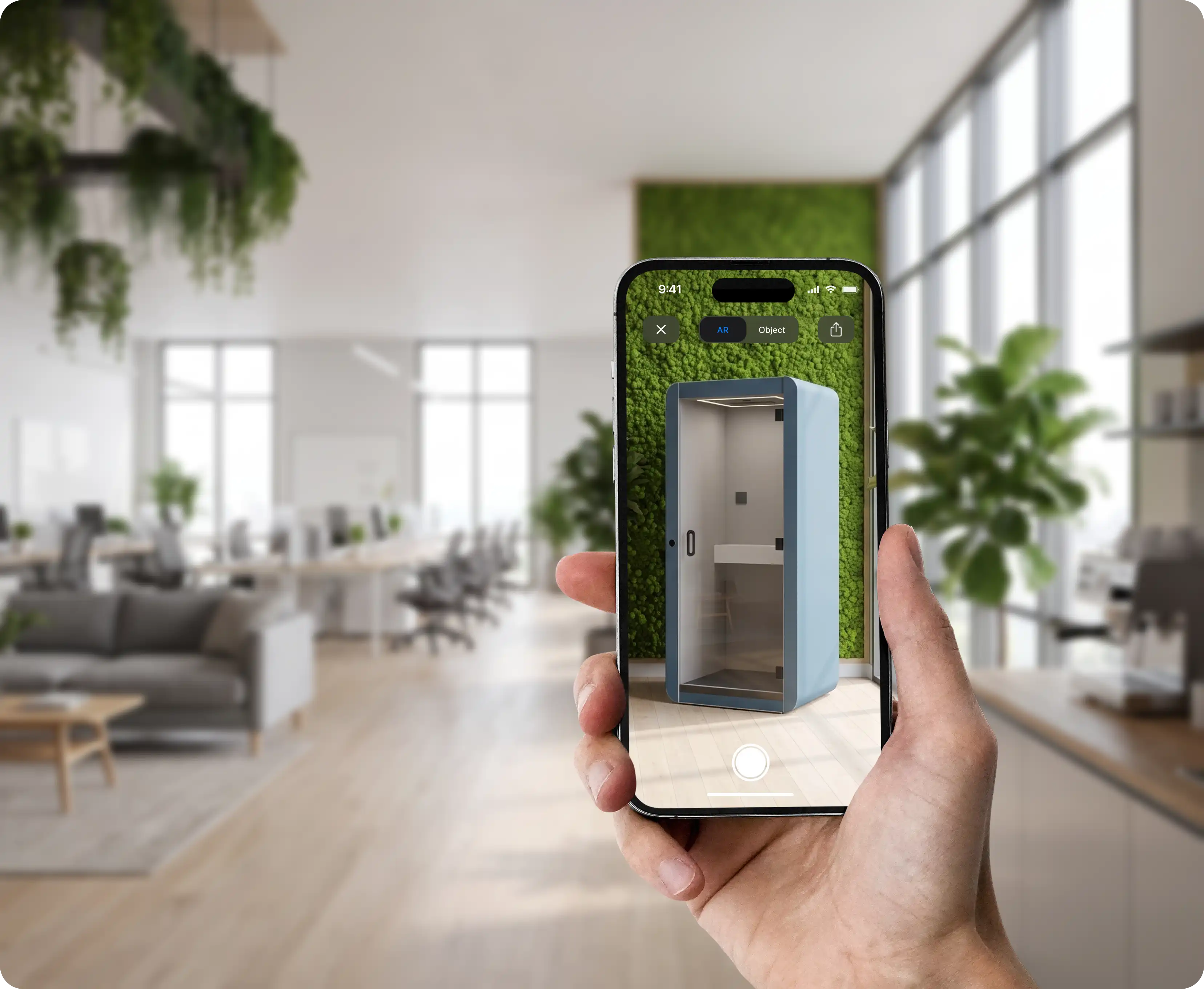 Hand holding iPhone showing a blue acoustic office pod placed in an office via AR configurator